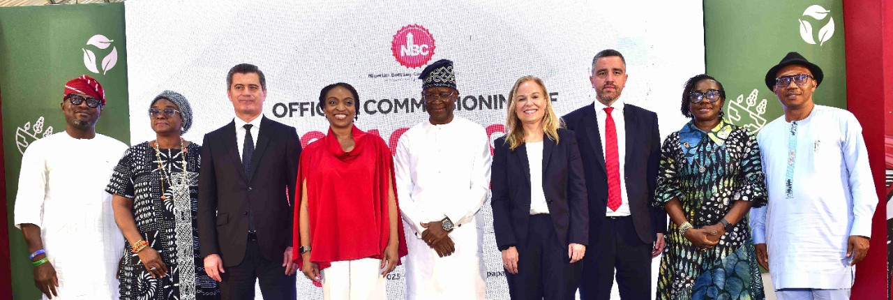 A group of eight people in formal attire stands together to launch a state-of-the-art Packaging Collection Hub in Lagos.