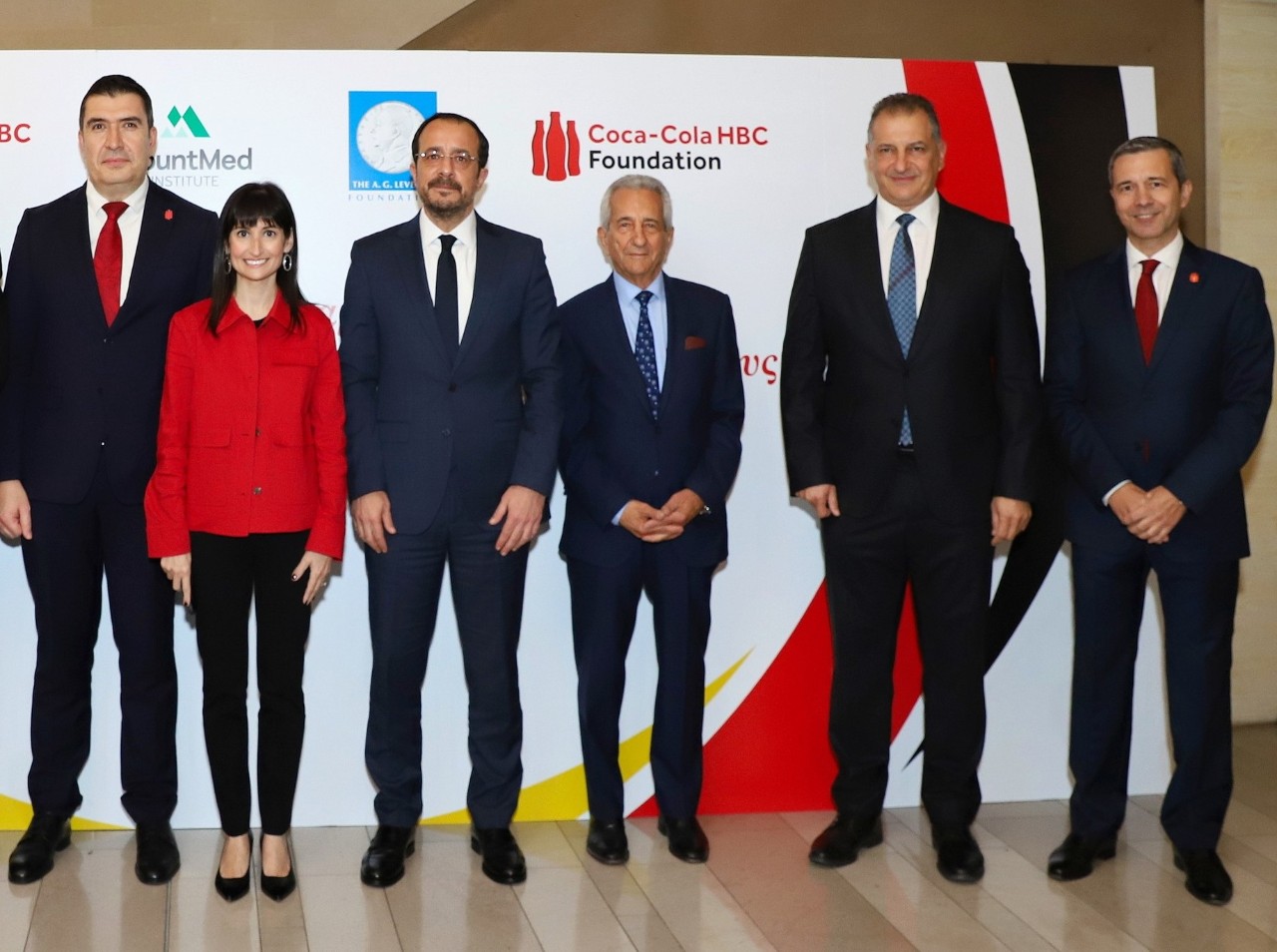 A group of eight people in formal attire stands together to launch a state-of-the-art Packaging Collection Hub in Lagos.